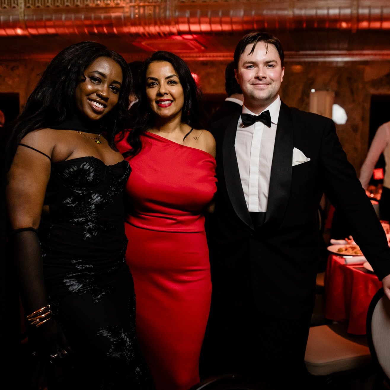Three attendees posing together at the Interior Design Hall of Fame gala.